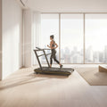 Athlete sprinting on a curved manual treadmill for HIIT cardio in a modern room with large windows and city view