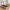 Pulserig Pilates reformer machine in a modern home gym with wooden floors and natural light, featuring a padded carriage and adjustable straps for core workouts.