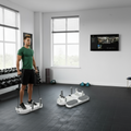 Person using a Pulserig fitness push up board resistance band feature in a gym setting with a TV on the wall.