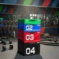 Professional plyometric boxes in commercial gym setting with weights and training equipment