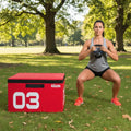 Athletic woman performing outdoor fitness training with red plyometric box in park setting