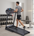 Man running on Pulserig folding treadmill in home gym setting